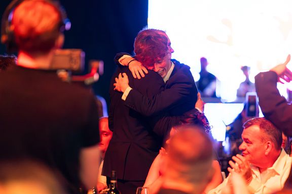 Two people celebrating award