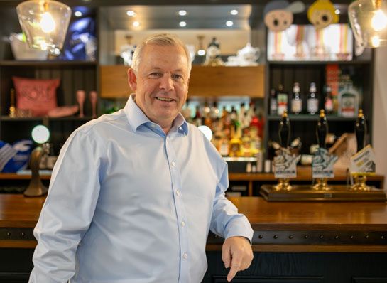 Ed Hancock standing at a bar