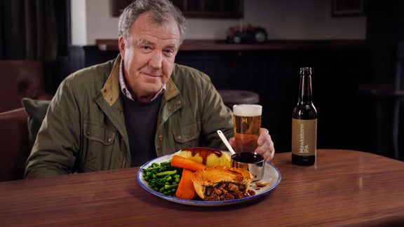 Jeremy Clarkson sitting at a pub table with Hawkstone IPA & Beef Pie