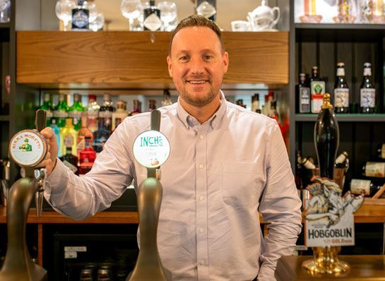 Liam Powell standing behind a bar