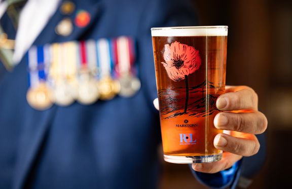 Commemorative pint glass being held