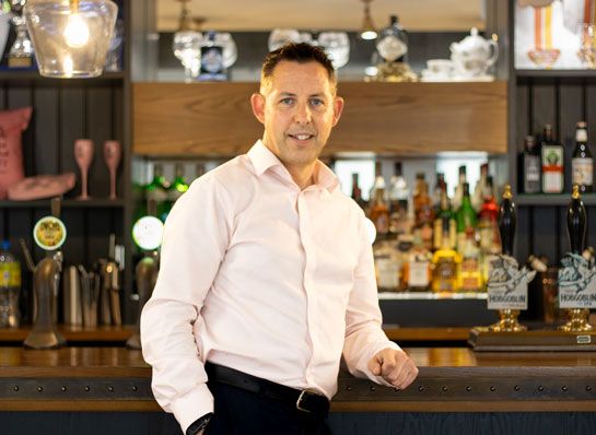 Neil Campbell standing at a bar