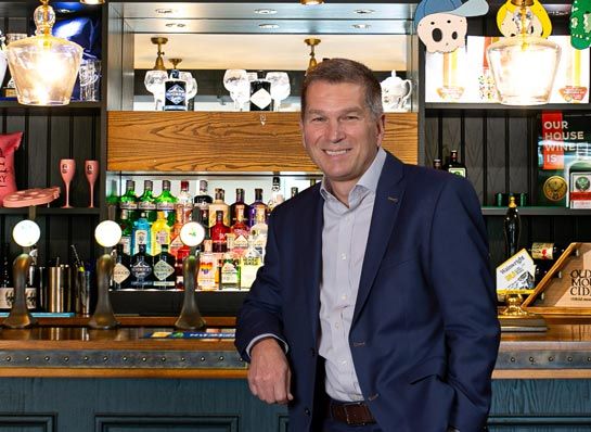 Photo of Nick Varney standing at a bar