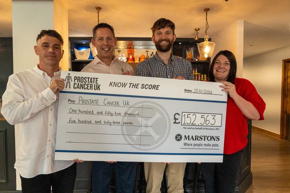 Team members holding up a cheque for £152,563