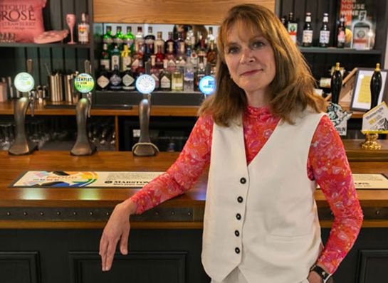 Photo of Rachel Osborne standing at a bar