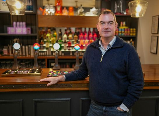 Photo of Rob Beattie standing at a bar